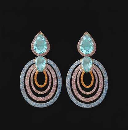 Rose gold colored earrings with turquoise colored zirconias